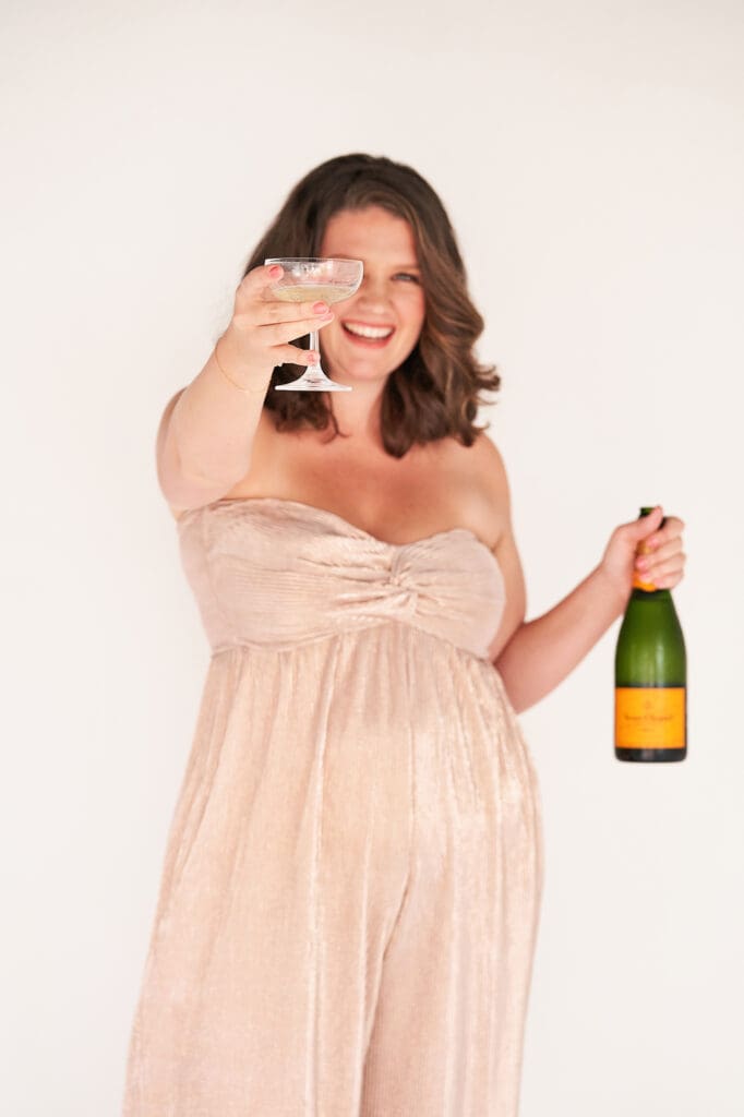 coach taylor lee celebrating new client with bottle of champagne