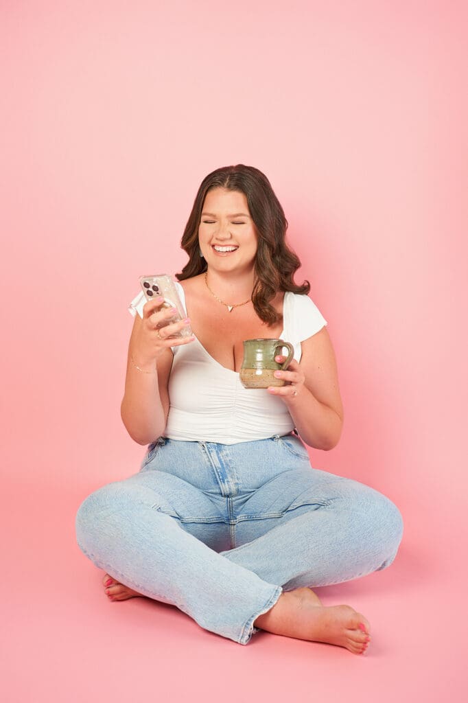 business coach taylor lee brand photo for course the soulmate coach soft pink background with her in white top and light blue jeans