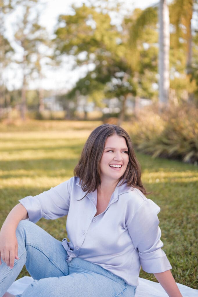 spiritual business coach brand photos with taylor lee in lavender top sitting in the grass