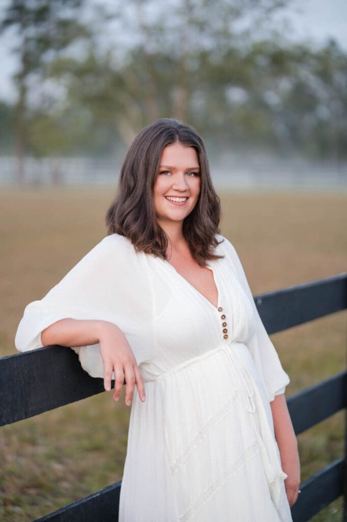 business coach taylor lee at her farm in Florida in white dress