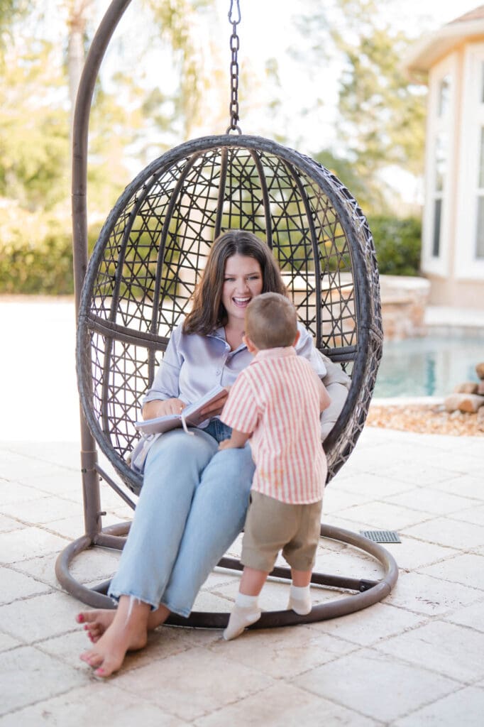 online CEO mentor photoshoot while being a mom and her young son comes in the shot