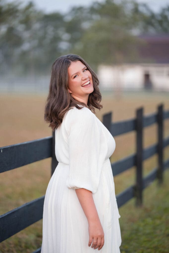 business coach taylor lee at her farm in Florida in white dress
