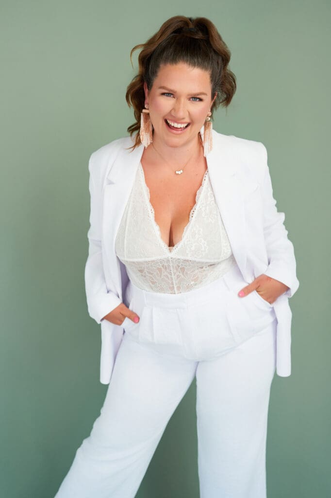 business coach photoshoot for taylor lee in white lace suit on sage green background