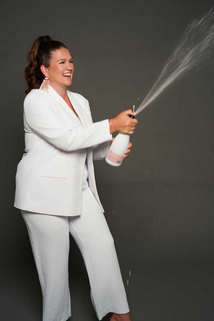 branding photos for course launches celebrating with spraying champagne